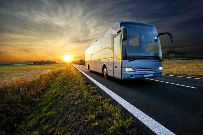 1345741577 featured image Bus driving on a road at sunset