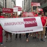Group holding IMMIGRATION EQUALITY banner at a parade