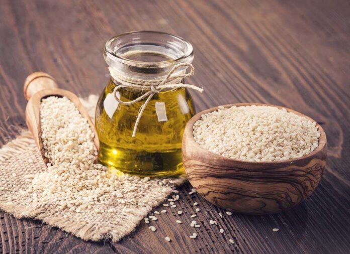 Jar of oil sesame seeds in bowl