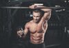 Muscular man in gym holding a shaker bottle