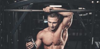 Muscular man in gym holding a shaker bottle