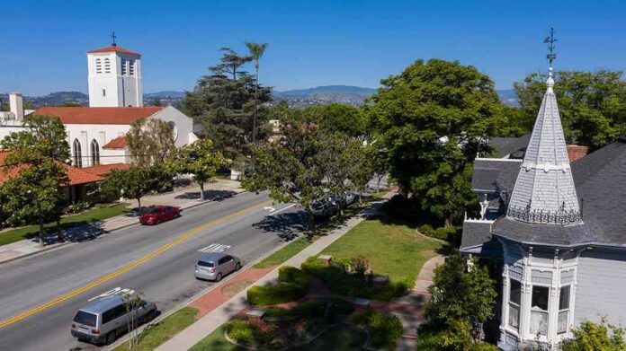 1864730230 featured image Street with church parked cars and trees