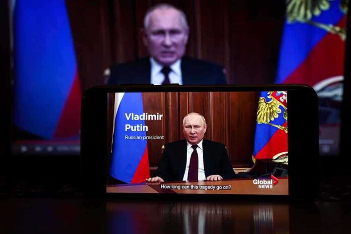 2127643805 featured image Man speaking on screen with Russian flag background