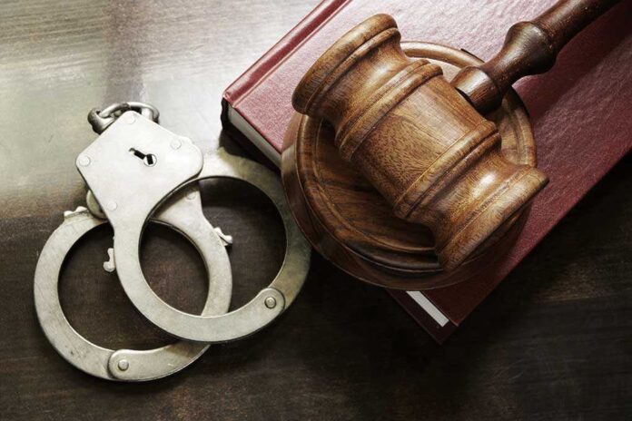 302738369 featured image Gavel handcuffs and book on wooden surface