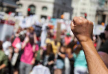 Raised fist in front of a crowd