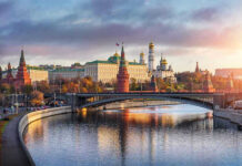 Kremlin by river at sunset with bridge