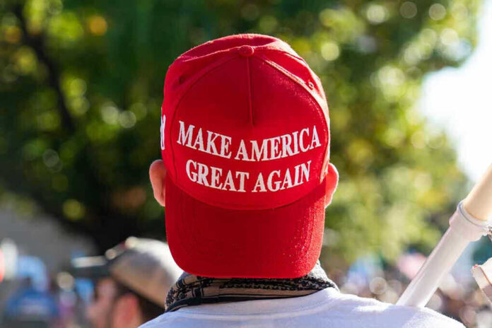 1850438311 Person wearing a red "Make America Great Again" hat.