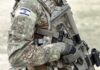 Soldier in camouflage gear with Israeli flag patch