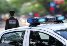 Police car and officer on a city street