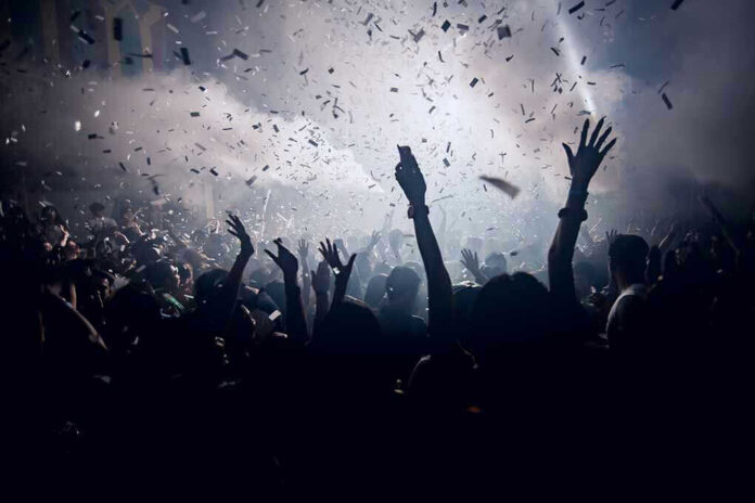 420455902 Crowd celebrating under confetti and bright lights