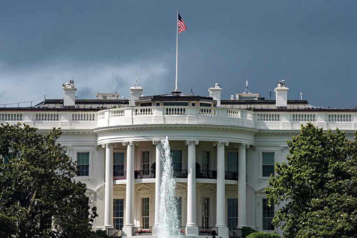 449346421 White House with American flag and fountain stormy sky