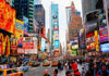 Times Square crowded with people and bright electronic advertisements