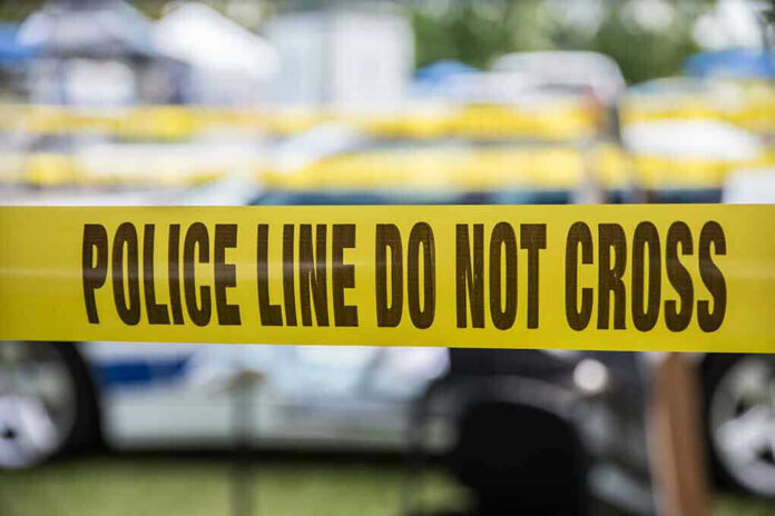 Yellow police line tape with Do Not Cross.