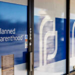 Planned Parenthood office entrance with logo and signs.