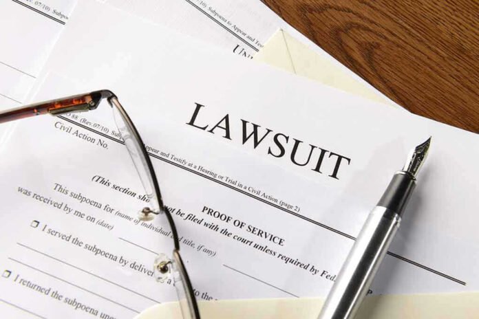 Lawsuit papers with glasses and pen on table.