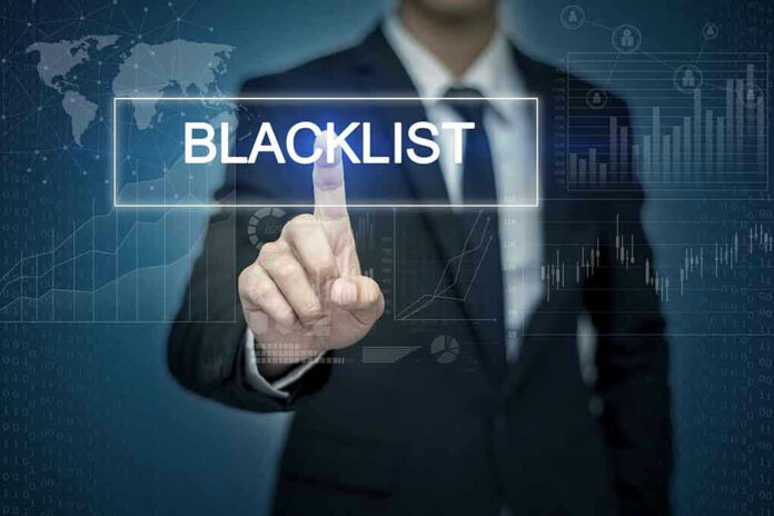 Man pressing virtual blacklist button.