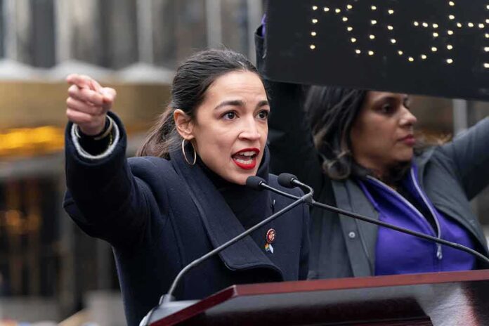 shutterstock_1289128096 (5).jpg A woman passionately speaking at a rally with a sign in the background
