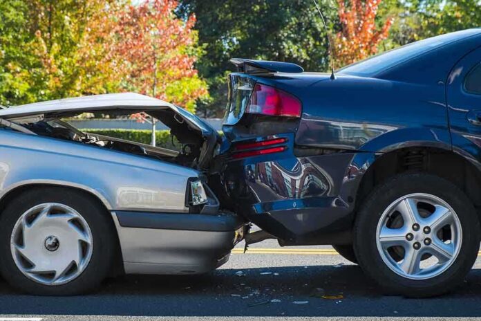 Two cars involved in a rear-end collision on a city street