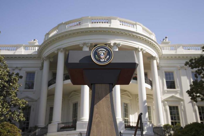 Press podium with presidential seal in front of the White House