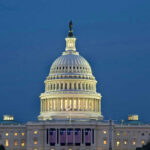 U.S. Capitol building illuminated at dusk.