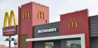 McDonalds restaurant exterior with logo and drive-thru sign.
