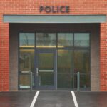 Police ABANDON Minneapolis – 40% Disappear Entrance of a modern police station with brick facade