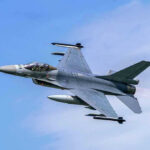 France BLOCKS U.S Planes – Shuts Airspace! Jet fighter flying through clear blue sky.