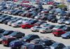 A crowded parking lot filled with various cars