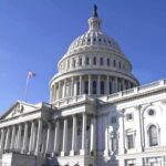 The U.S. Capitol building with a clear blue sky in the background