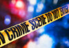 SICKO Illegal Alien Raped Body of a Corpse for 30 Minutes! Yellow crime scene tape with blurred lights background.