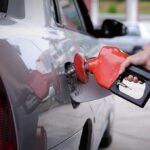 A person refueling a car at a gas station