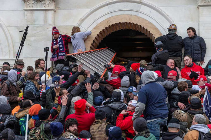 Large crowd storming the entrance of a building.