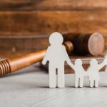 Paper cutout family with gavel in background