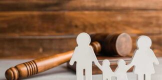 Paper cutout family with gavel in background