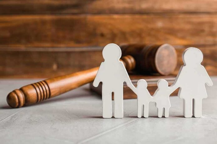 shutterstock_1108919288 Paper cutout family with gavel in background