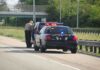 Trump DEMANDS ICE Resume Traffic Stops Despite 2 Fatal Shootings Police officer conducting a traffic stop on a highway