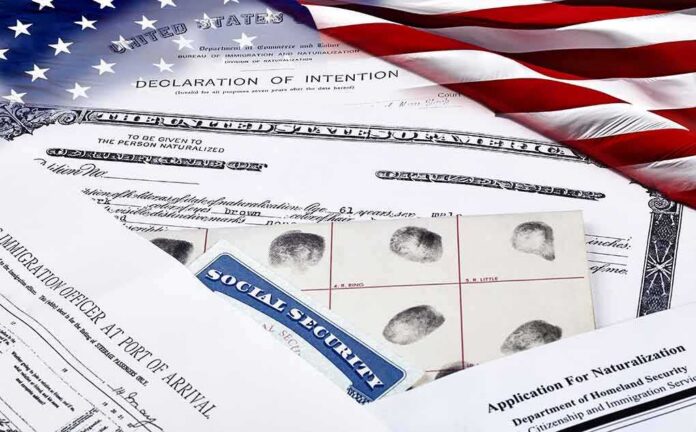 shutterstock_409680562 U.S. immigration and naturalization documents with American flag