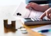 Hands calculating student loan with document and calculator
