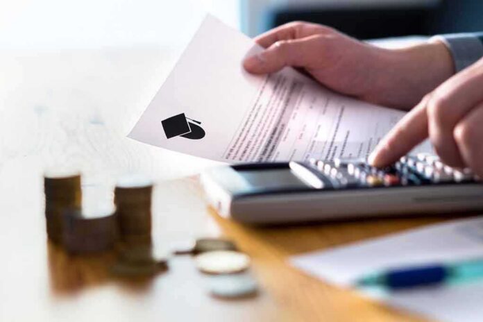 Hands calculating student loan with document and calculator