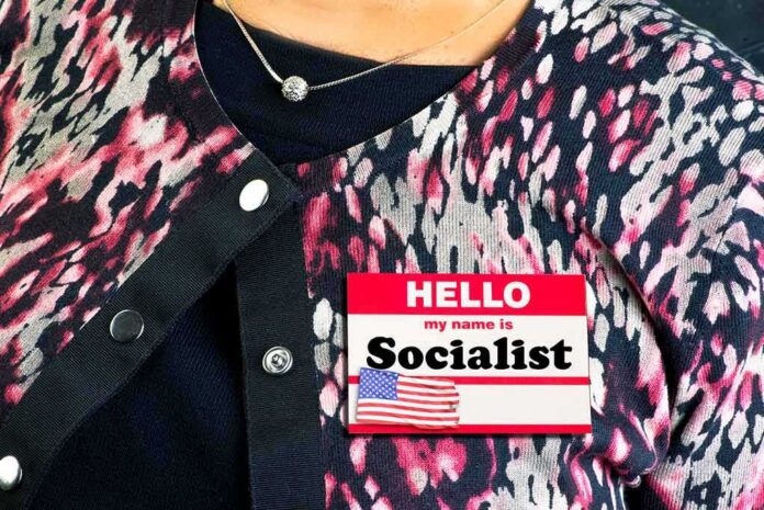 Person wearing patterned cardigan with a name badge on chest