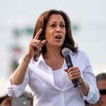 Kamala’s Endorsement Snubbed — Dem Says NO THANKS! Woman in white shirt speaking into a handheld microphone
