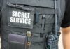 Tactical vest with Secret Service patch and gear