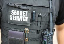 Tactical vest with Secret Service patch and gear