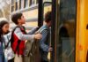 Children boarding a yellow school bus