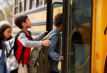 Children boarding a yellow school bus