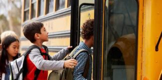 Children boarding a yellow school bus