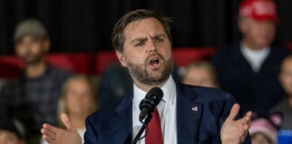 Man in suit speaking at a podium