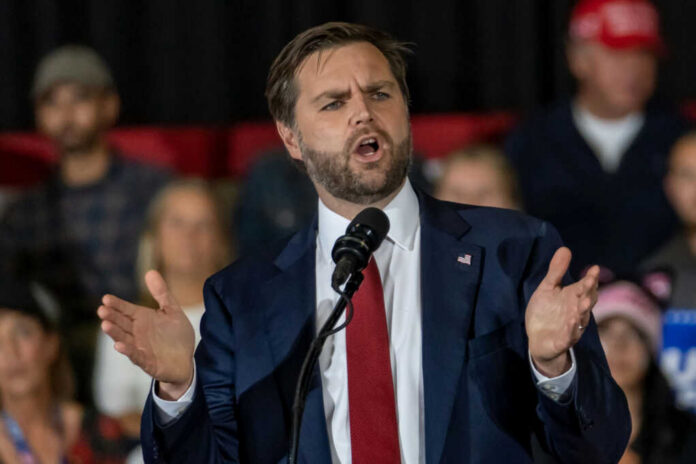 54801cb8-0515-4c34-a2d8-f79705e6683e_shutterstock2542628059jpg Man in suit speaking at a podium