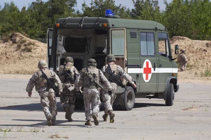 Soldiers running towards a medical vehicle during a military operation