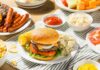 Burger Icon SHUTS Hundreds of Locations – Beef Crisis! Cheeseburger on a plate with potato salad and corn on the cob